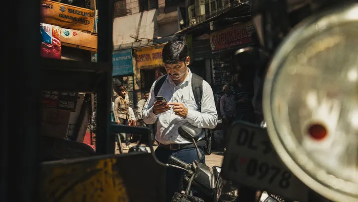 Field sales agent using a map tracking app in a market street